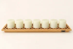 A 7-pack of non-toxic silicone light cores resting on a carved bamboo charging dock with magnetic brass contacts and a Type-C port.