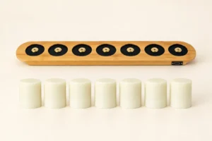 A 7-pack of non-toxic silicone light cores lined up in front of a plain bamboo charging dock with magnetic brass contacts and a Type-C port.