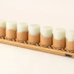 A 7-pack set of rechargeable flameless candles on a carved bamboo charging dock with a Type-C port, featuring magnetic pods, offering up to 30-hour and 48-hour runtime versions.
