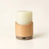 A single rechargeable flameless candle featuring a silicone light core mounted on a beech wood pod with a built-in backup battery, showing its USB Type-C charging port and offering 30-hour and 48-hour runtime versions.